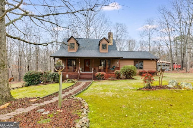 view of front of home featuring covered porch, roof with shingles, a chimney, and a front yard