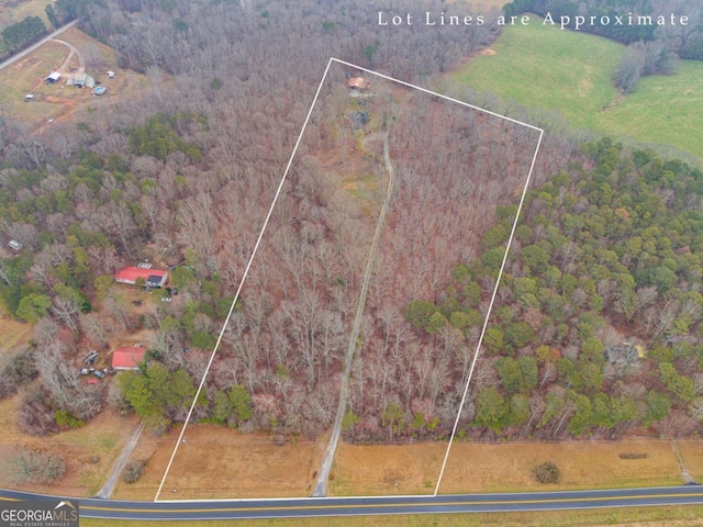 drone / aerial view with a forest view and a rural view