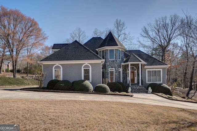 view of front of home with a front lawn and stucco siding