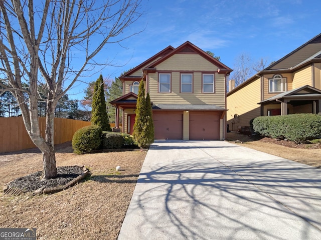 view of front of house with driveway, brick siding, an attached garage, and fence