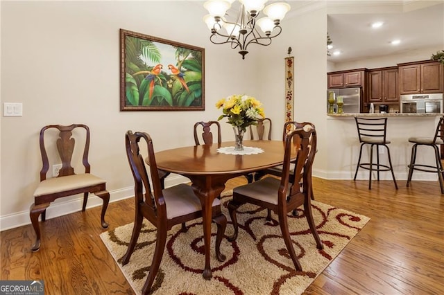 dining room with baseboards, recessed lighting, dark wood finished floors, and a notable chandelier