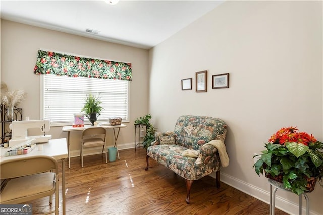 office space with visible vents, baseboards, and wood finished floors