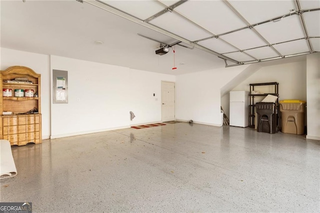 garage featuring baseboards, electric panel, freestanding refrigerator, and a garage door opener