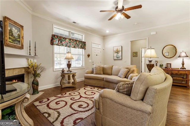 living area featuring baseboards, dark wood-type flooring, a fireplace with flush hearth, and crown molding