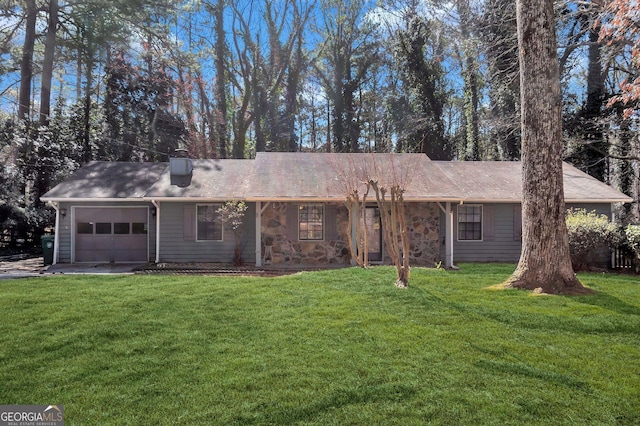 back of property featuring an attached garage and a lawn