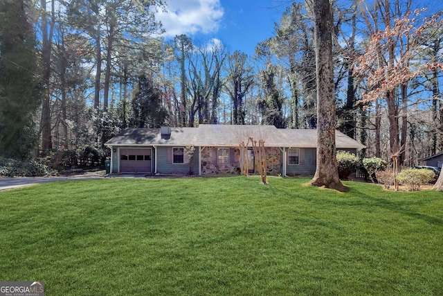 ranch-style home with a front yard, driveway, and an attached garage