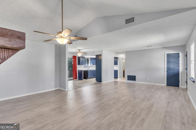 unfurnished living room featuring light wood-style floors, baseboards, and visible vents