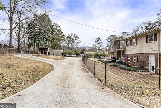 view of street with concrete driveway