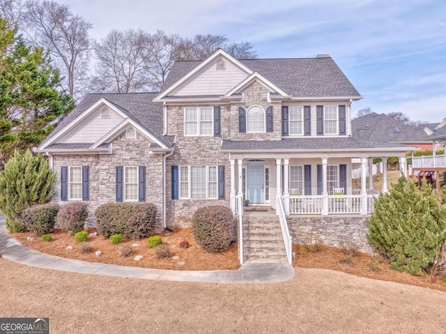 view of front of home featuring a porch, stone siding, and a shingled roof