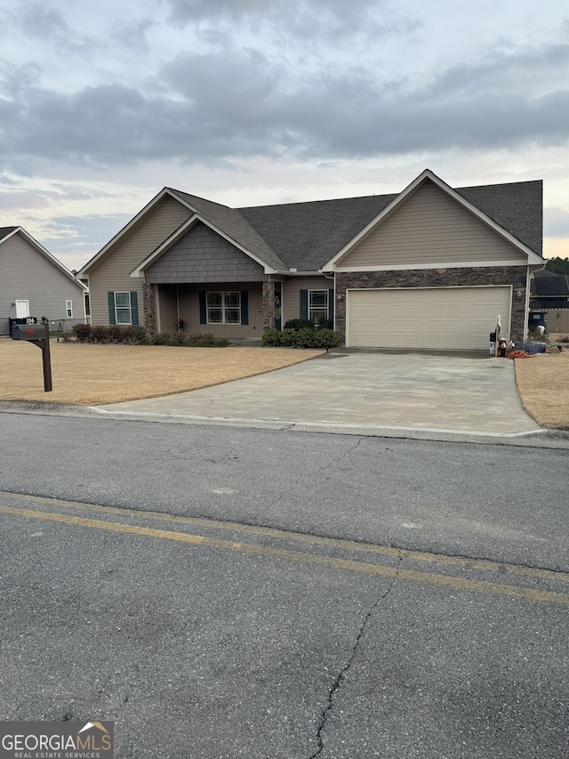 view of front of property with driveway and a garage