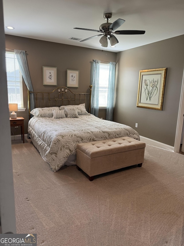 bedroom featuring ceiling fan, carpet, visible vents, and baseboards