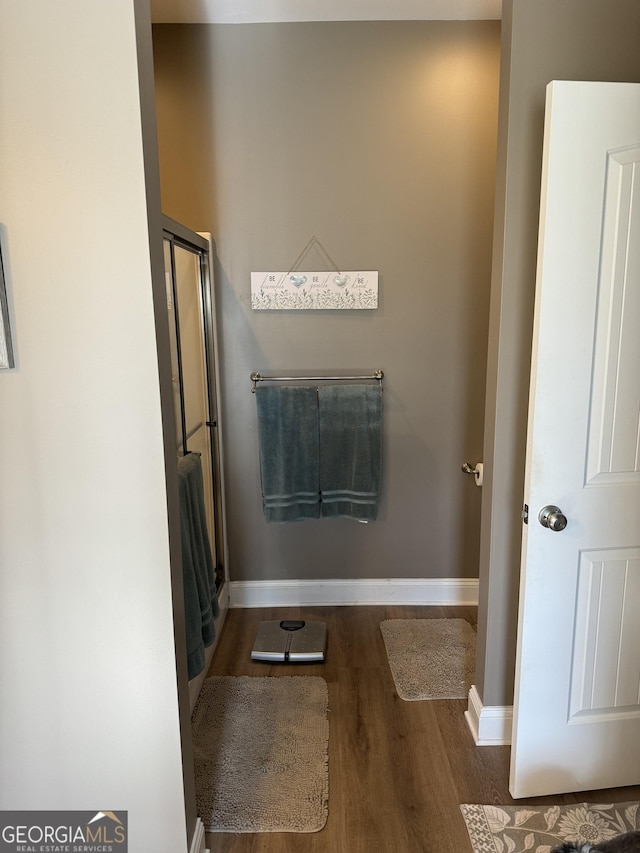 bathroom with baseboards and wood finished floors