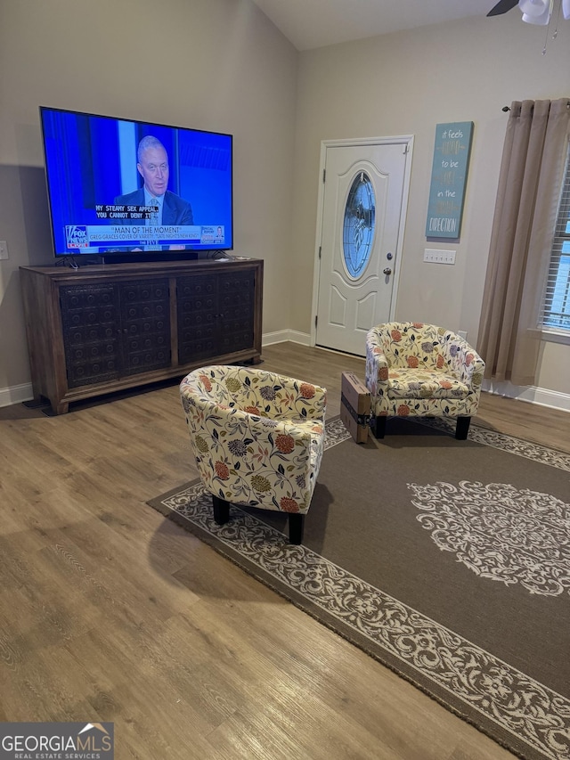 sitting room featuring baseboards and wood finished floors