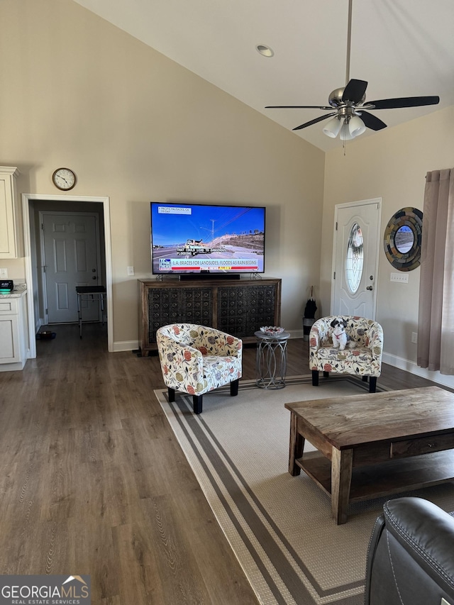 living area featuring high vaulted ceiling, ceiling fan, baseboards, and wood finished floors