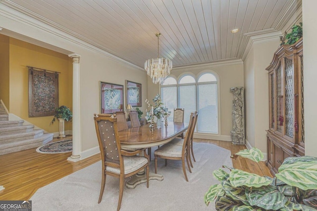 dining area featuring crown molding, wood ceiling, wood finished floors, a chandelier, and stairs