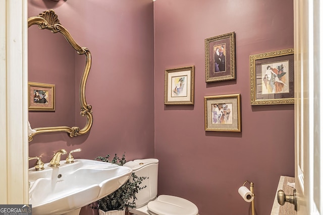 bathroom with toilet and a sink