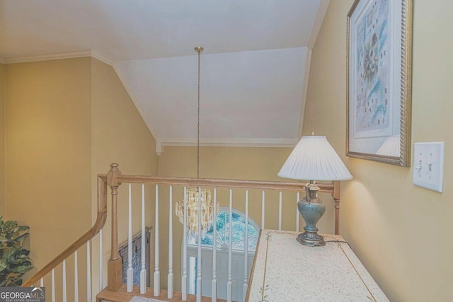 hall featuring ornamental molding, lofted ceiling, and a notable chandelier