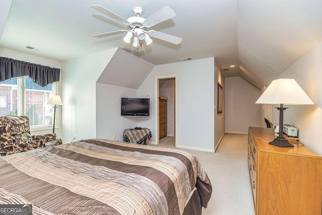 bedroom featuring visible vents, vaulted ceiling, and light colored carpet