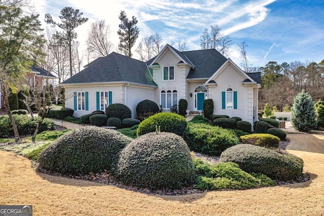 traditional-style house featuring stucco siding