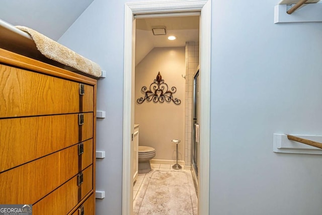 bathroom with baseboards, a shower stall, toilet, and tile patterned floors