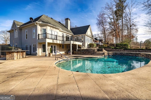 outdoor pool featuring a patio area, fence, area for grilling, and french doors