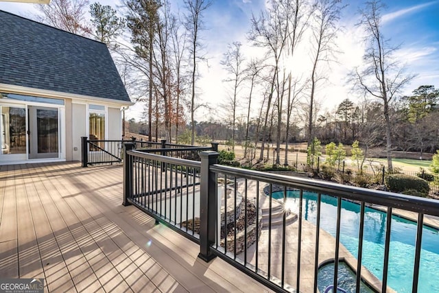 deck featuring a fenced in pool