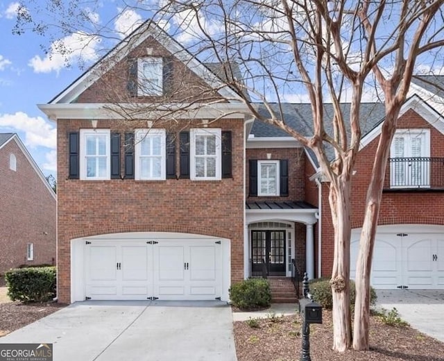 view of front of property with brick siding, driveway, and an attached garage