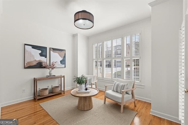 sitting room with light wood-style floors and baseboards