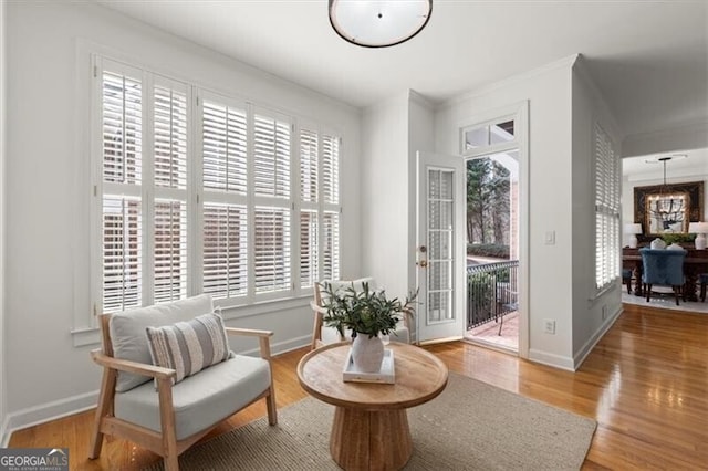 living area featuring baseboards and wood finished floors