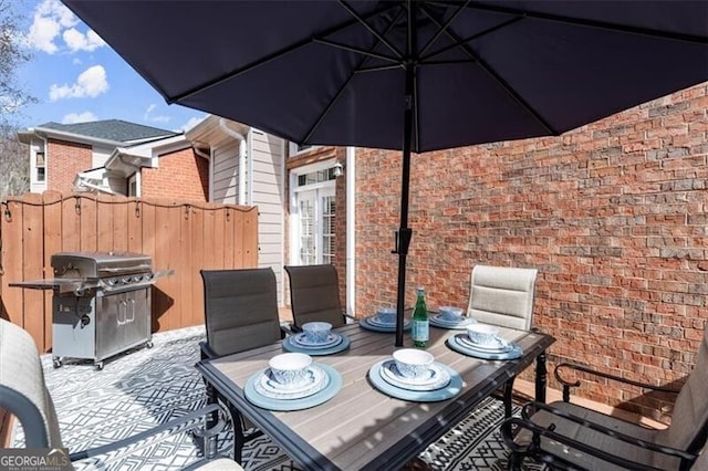 view of patio / terrace featuring outdoor dining space and grilling area