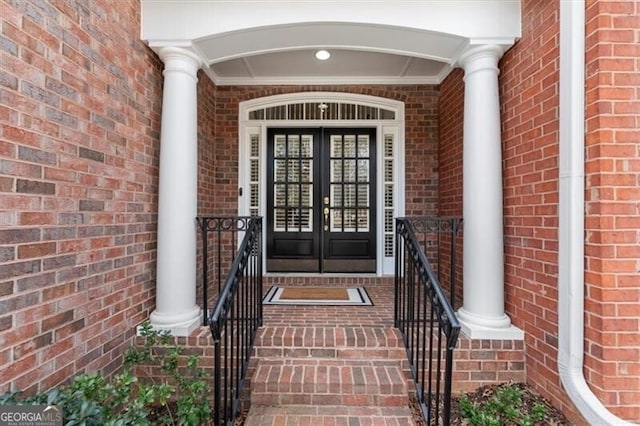 property entrance with french doors and brick siding