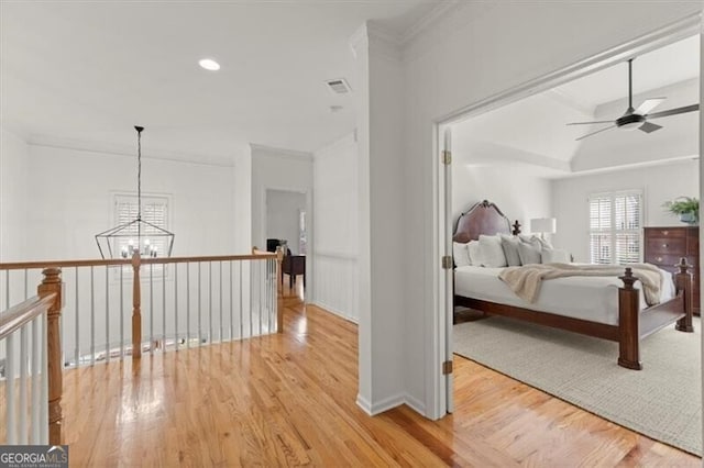 bedroom featuring visible vents, wood finished floors, crown molding, a notable chandelier, and recessed lighting