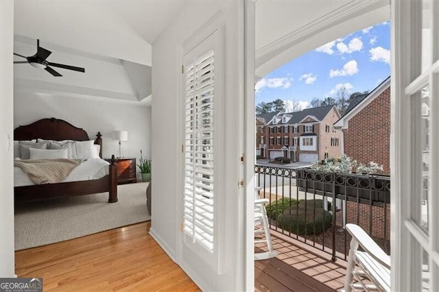 bedroom featuring access to exterior, ceiling fan, and wood finished floors