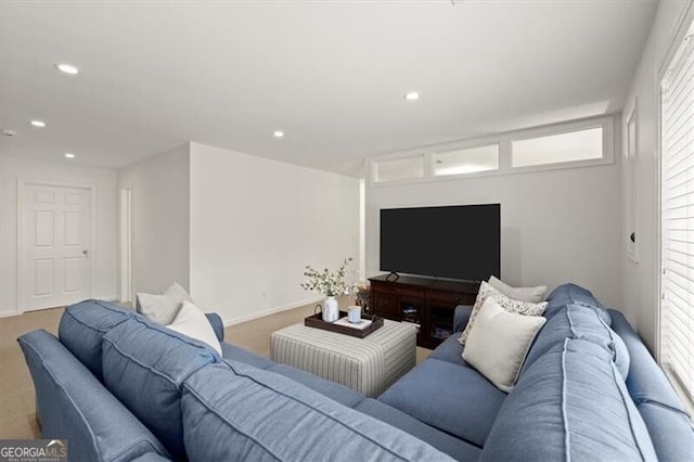 carpeted living area with recessed lighting and baseboards