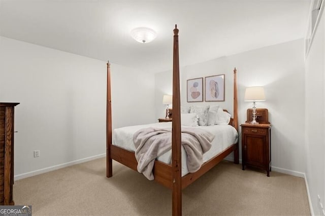 bedroom with light carpet and baseboards