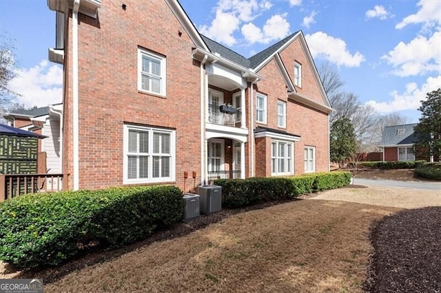 view of home's exterior with cooling unit and brick siding