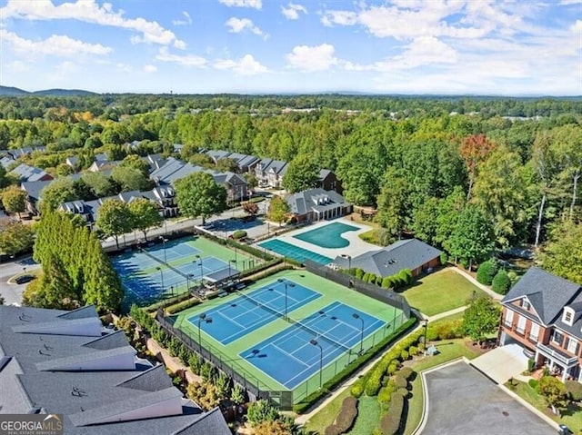 drone / aerial view with a wooded view