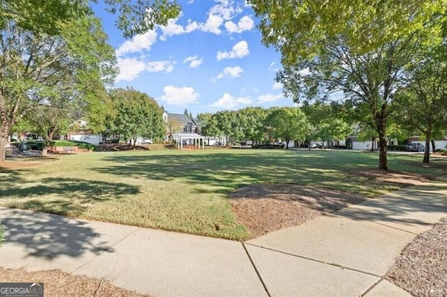 view of home's community featuring a pergola and a yard