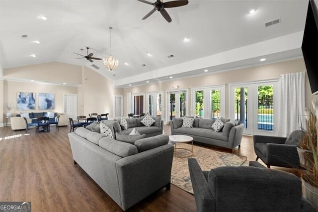 living area featuring high vaulted ceiling, recessed lighting, visible vents, and dark wood finished floors