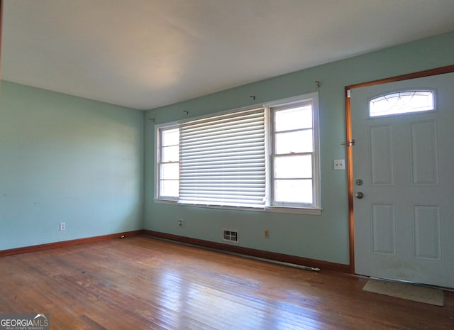 entrance foyer with visible vents, baseboards, and wood finished floors