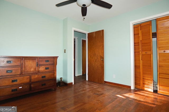 unfurnished bedroom with ceiling fan, dark wood finished floors, and baseboards