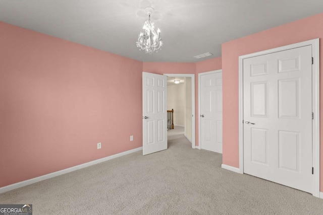 unfurnished bedroom with light carpet, visible vents, baseboards, and a chandelier