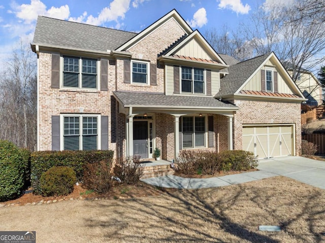 view of front of property with driveway, a shingled roof, board and batten siding, and brick siding