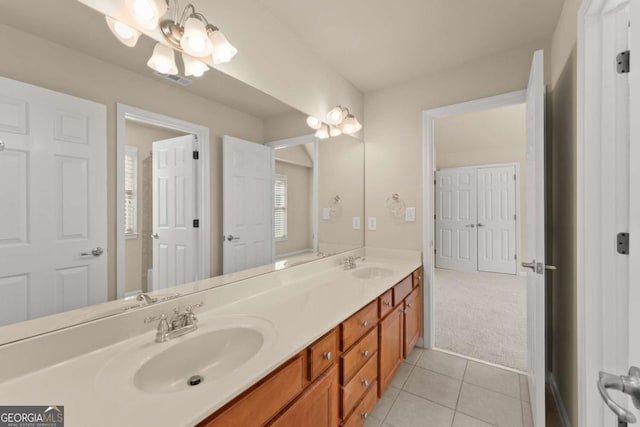 bathroom with double vanity, tile patterned flooring, and a sink