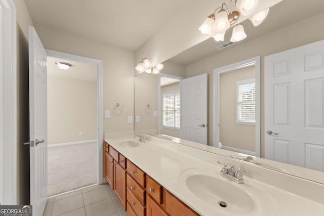 bathroom featuring double vanity, tile patterned flooring, and a sink