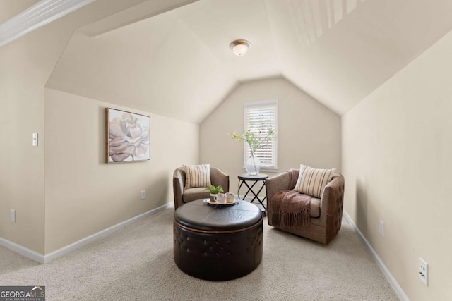 living area with lofted ceiling, baseboards, and light colored carpet