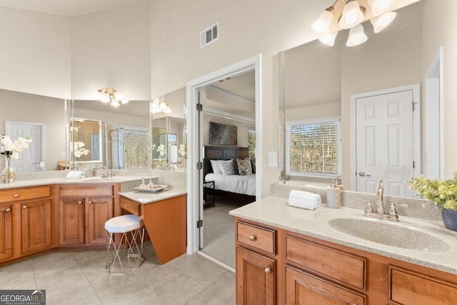 ensuite bathroom with visible vents, a towering ceiling, vanity, ensuite bath, and tile patterned flooring