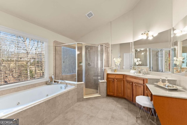 full bathroom featuring lofted ceiling, vanity, visible vents, a jetted tub, and a stall shower