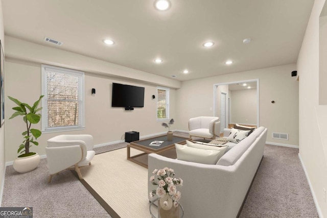 living area with light colored carpet, visible vents, and recessed lighting