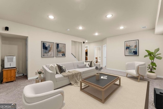 living area with light carpet, baseboards, visible vents, and recessed lighting